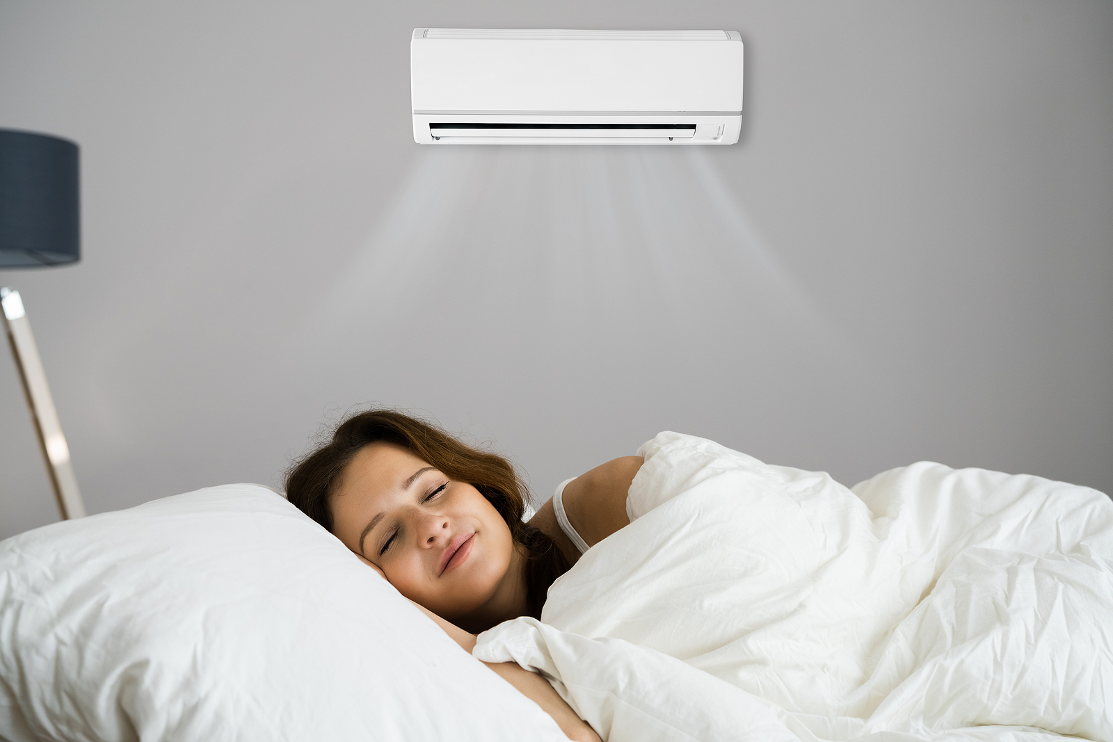Alt text: Bedroom with split system air conditioning providing a cool, comfortable sleep environment at night