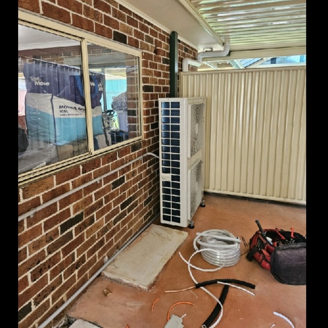 Daikin ducted outdoor unit installed under the patio of a St Andrews home.