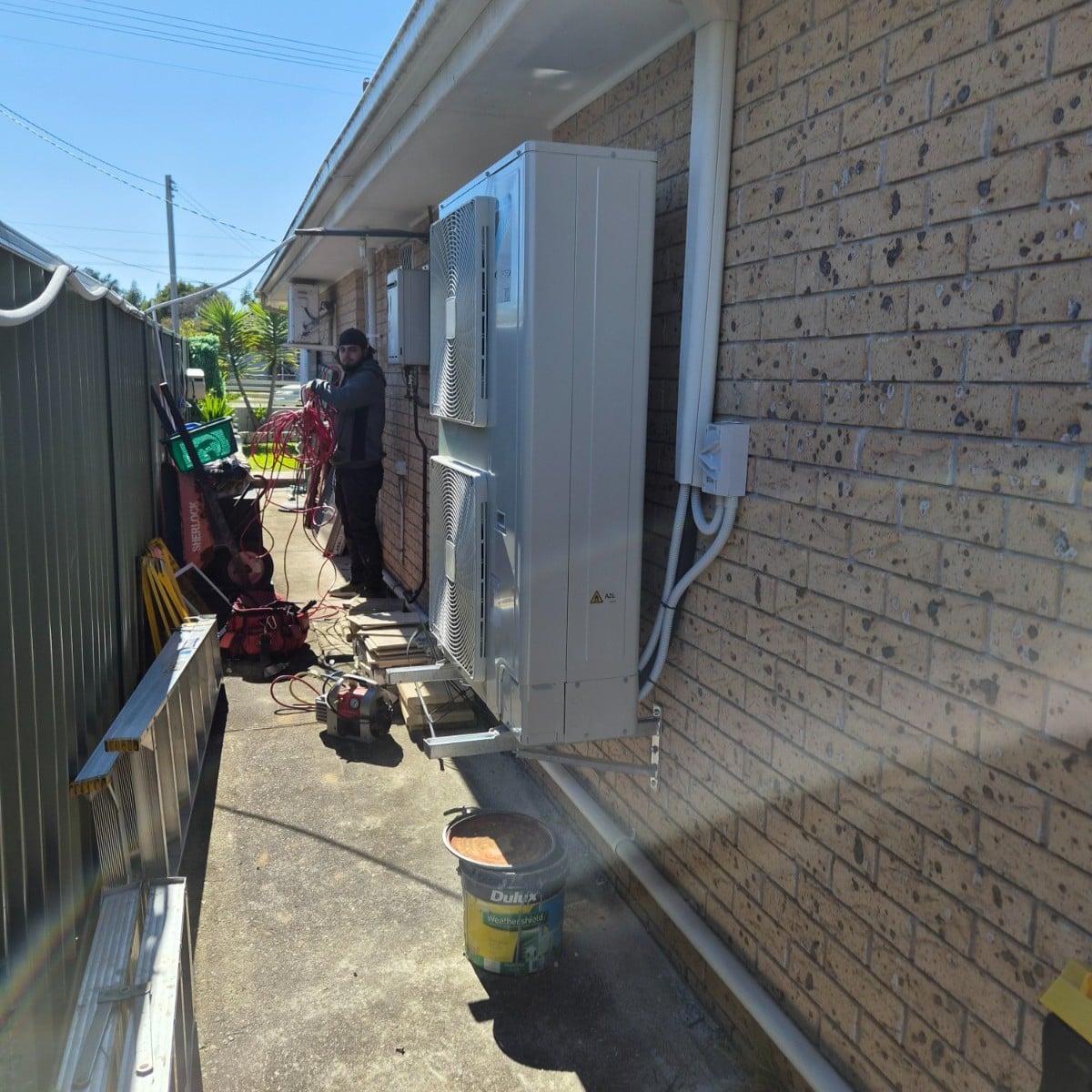 New Daikin ducted outdoor unit wall-mounted beside a brick home in Mount Druitt