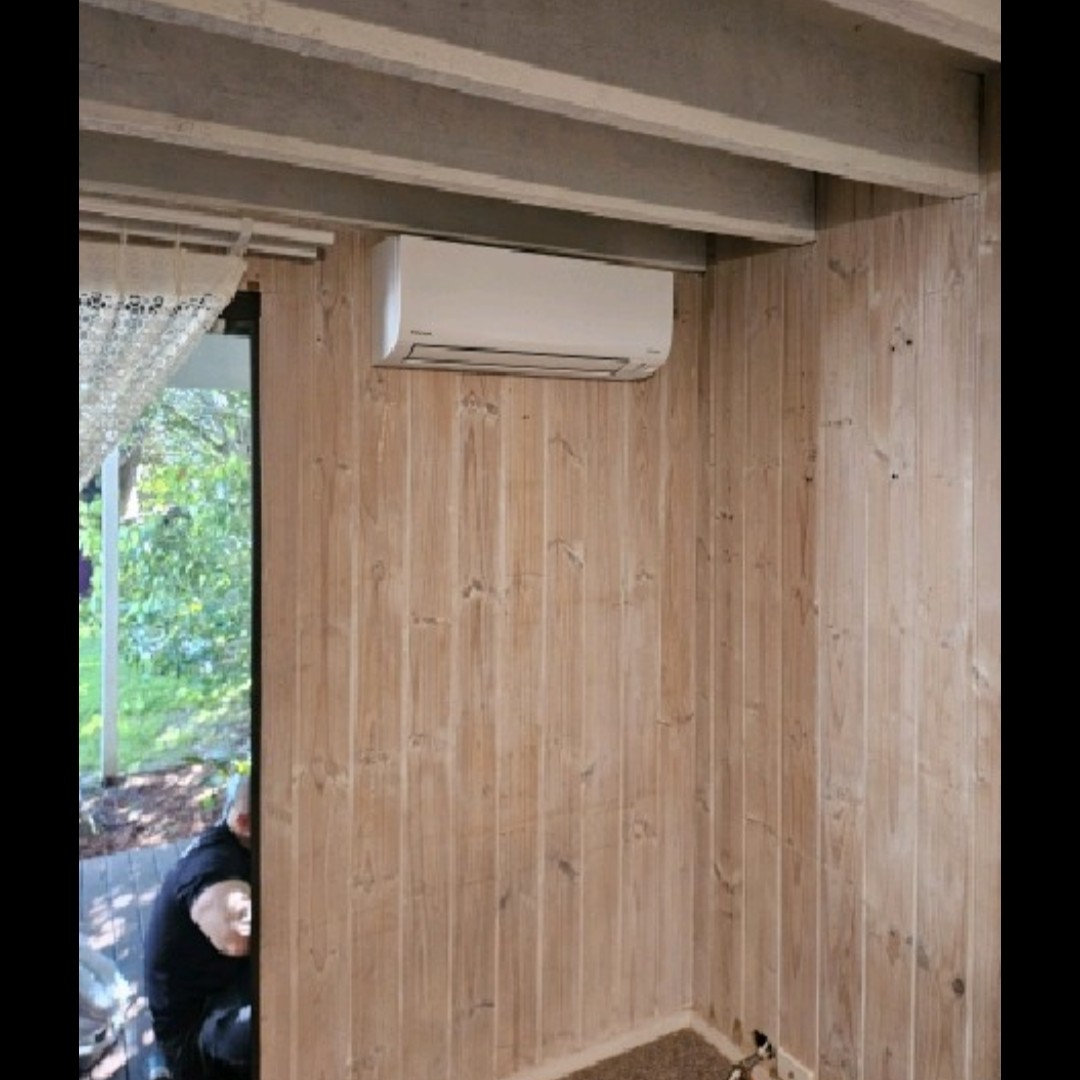 Daikin Cora split system indoor unit on a timber-lined wall in a Galston home.
