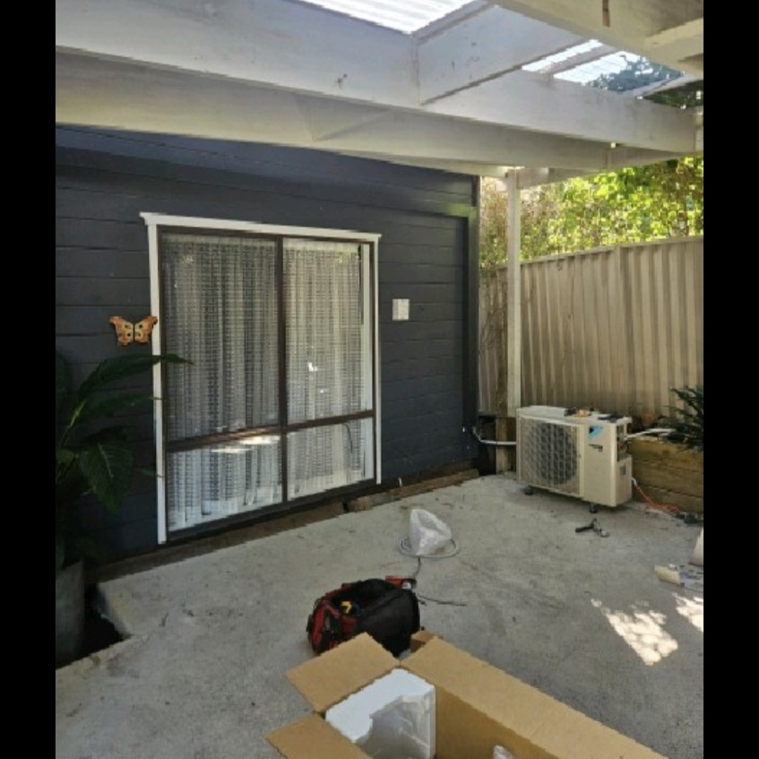 Daikin Cora split system outdoor unit installed under a pergola at a Galston home.